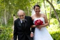 A proud father escorts his daughter through the tree-lined walkway