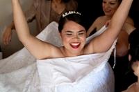 The ladies of the bridal party assist the bride with her final preparation