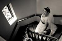 The bride, all dressed and prepped, descending the stairs just before the ceremony begins
